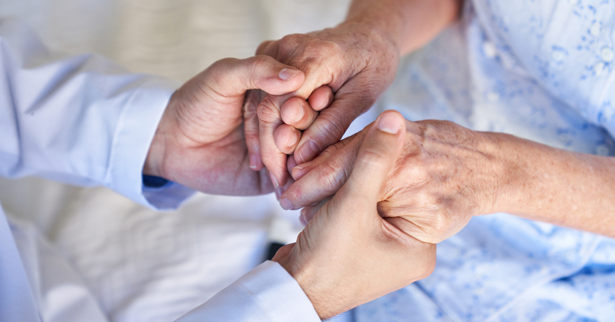Medical professional comforting elderly patient